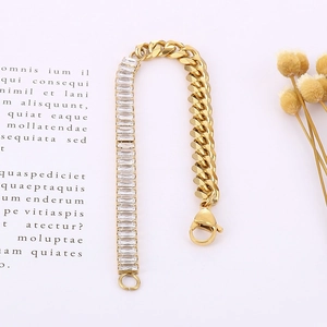 Gold Cuban chain bracelet featuring baguette-cut zircon splicing and lobster clasp