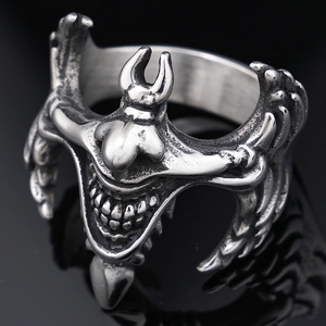 Macro shot of gothic evil smile ring in vintage silver with detailed metal engraving