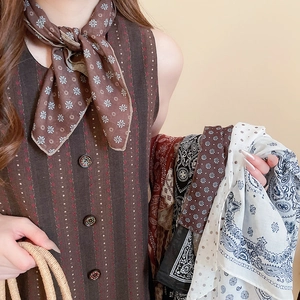 Detailed view of vintage floral and polka dot scarves with elegant silk texture