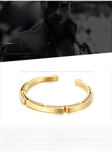 Macro detail of men's geometric stainless steel bangle with gold finish and measurements