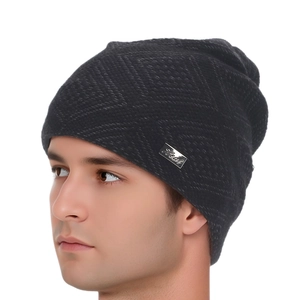 Detail of the dark gray knit beanie fabric texture and silver metal brand logo tag