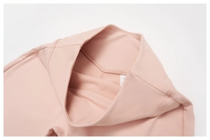 Detail of high-waist yoga leggings featuring size S tag and soft pink elastic fabric