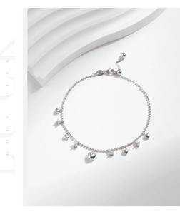 Detailed macro of 925 sterling silver heart charm bracelet with zircon stones