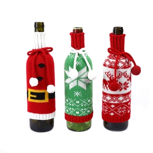 Three Christmas knitted wine bottle covers with Santa, snowflake and reindeer patterns
