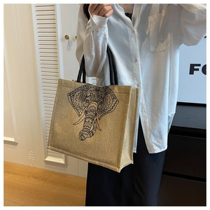 Detailed close-up of large linen tote bag with black elephant mandala print on shoulder