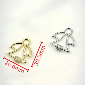 Macro shot showing dimensions of gold and silver angel pendants with cubic zirconia