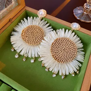 Vintage bohemian daisy earrings with white silk petals and woven straw center details