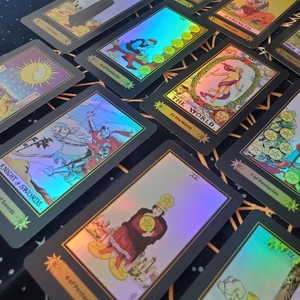Detailed macro view of holographic tarot cards with rainbow reflections on black fabric