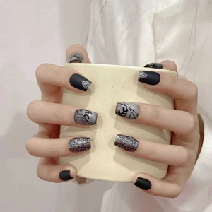 Press-on nails with black matte, silver foil, marble patterns and cat-eye finish