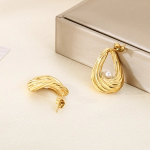 Elegant gold drop earrings with textured twist design and center pearl accent