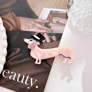 Detailed view of pink marble dachshund hair clip with rhinestone and black hat