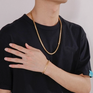 Detail shot of men's gold Byzantine box chain necklace and bracelet set on model