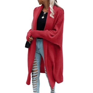 Detail of red oversized batwing sleeve long cardigan with chunky knit texture