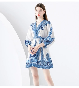 Detail of blue and white boho print mini dress with V-neck and lantern sleeves