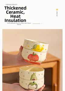 Close-up of heat-resistant ceramic fruit bowls with cute lemon and apple patterns