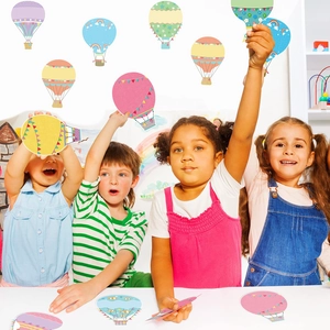 Children holding colorful hot air balloon paper cutouts for back to school classroom decor