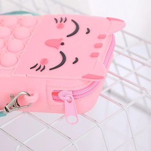 Detail of pink silicone cat bag zipper and pop bubble texture with metal buckle