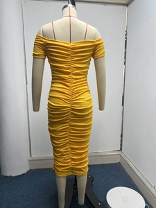Detail of bright yellow off-shoulder dress featuring elastic horizontal pleat design