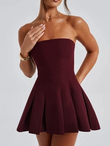 Detail view of burgundy strapless dress featuring pleated skirt and shaping waist design