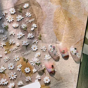 3D embossed daisy nail stickers set with floral patterns and letter decals on textured paper