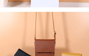 Detailed close-up of three crossbody phone bags in brown, black, and yellow leather