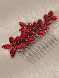 Detail view of two bridal hair combs with vibrant red marquise rhinestones in silver settings