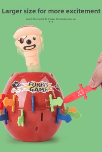 Action shot of pirate toy popping out of red barrel with multi-colored plastic swords
