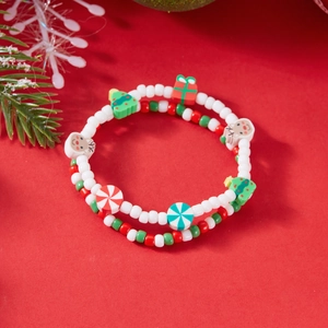 Close-up of Christmas beaded bracelets with festive tree, elk, and candy pendants