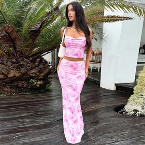 Pink tie-dye two-piece set featuring a cropped camisole and maxi skirt in a resort style