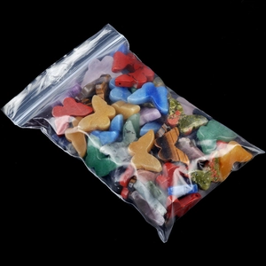 Polished natural crystal butterfly stones in a clear bag for colorful desk decor