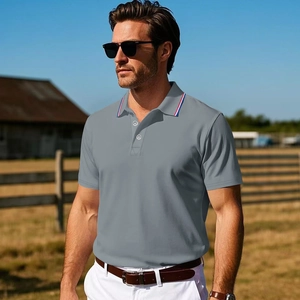 Detail of grey polo shirt with red white and blue striped collar on a male model
