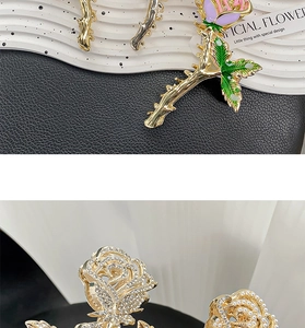 Detailed macro view of rose hair claws featuring enamel petals and rhinestone crystal inlay