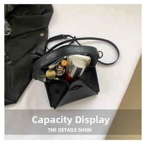 Interior view of black geometric folding bag showing storage capacity for cosmetics