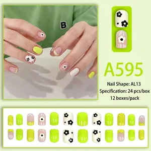 Short press-on nails with floral patterns in fluorescent yellow and white shades
