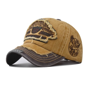 Detail of vintage baseball cap featuring 1984 New York eagle embroidery and frayed edges