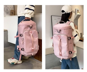 Pink multipurpose nylon travel backpack with large capacity and hand straps in use