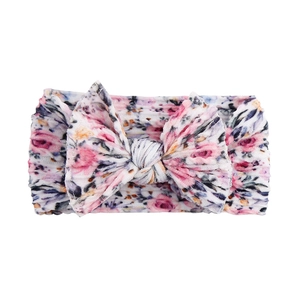 Detailed view of floral print baby headband with a soft double-layer nylon bow accent