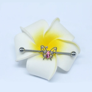 Industrial barbell piercing with silver long bar and gold butterfly with pink zircon