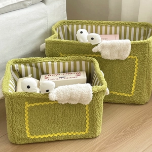Green sherpa monster storage baskets with cute animal faces and wings for home organizing
