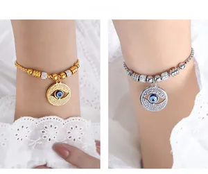 Detail of beaded evil eye bracelets in gold and silver finish with crystal pavé cylinders