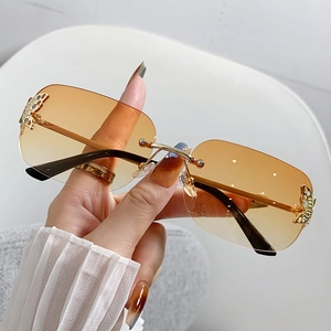 Frameless square sunglasses with orange gradient lenses and diamond butterfly metal detail