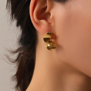 Elegant gold S-shaped spiral titanium steel earring on female model for a chic look