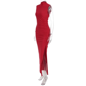Detail of red sleeveless ruched dress featuring side slit and high neck design