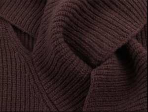 Close-up of thick ribbed knit fabric in deep reddish brown for autumn winter sweaters