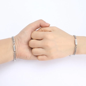 Close-up of silver stainless steel bracelets with Forever and Always engraving