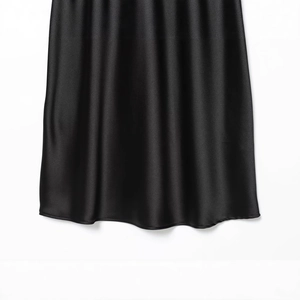 Elegant black satin maxi dress with silky texture and smooth drape in a minimalist style