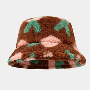 Detailed view of plush bucket hat with retro green arrow and pink lip patterns