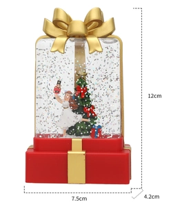Macro detail of Christmas gift box snow globe with dimensions 12x7.5x4.2cm and internal scene