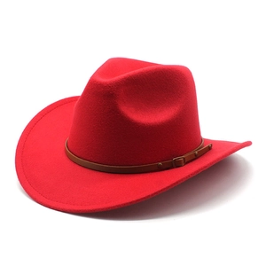 Detail of red cowboy hat featuring a wide brim and brown leather decorative band buckle