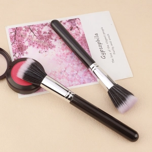 Black handle duo brush set with gradient bristles and blush palette on beige background